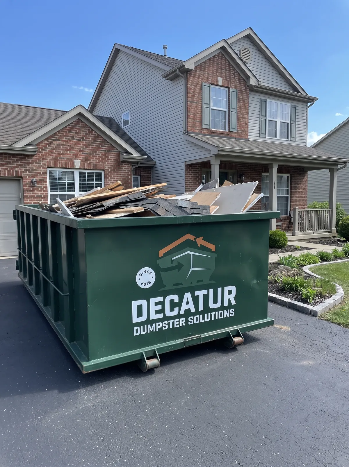 Green roll-off dumpster delivered to a residential property in Decatur, Illinois
